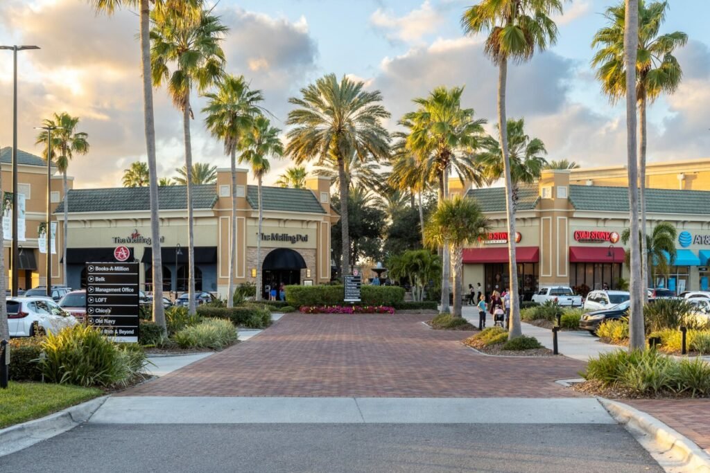 Shops and palm-lined walkways at The Avenue Viera near beautiful homes for sale in Viera, FL
